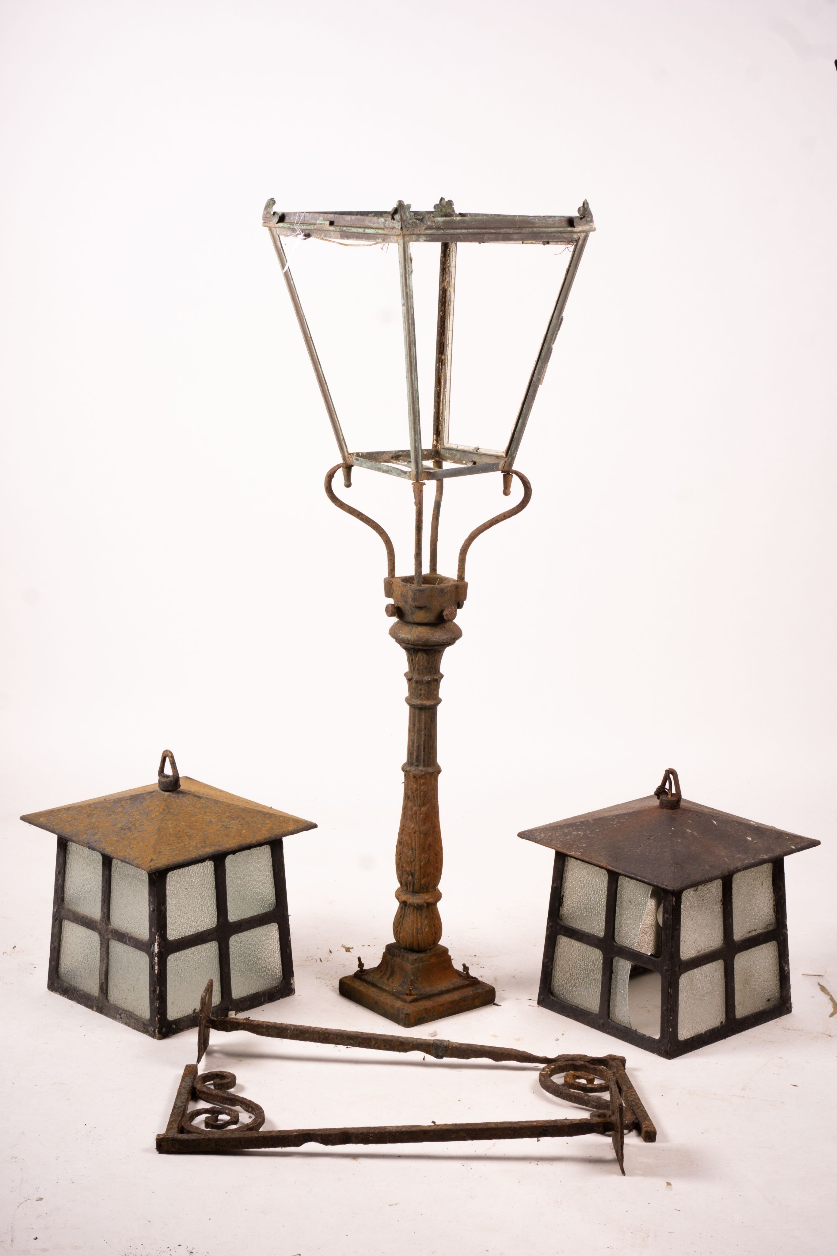 A Victorian style lantern on cast iron base, height 143cm together with a pair of lanterns and a pair of fire dogs